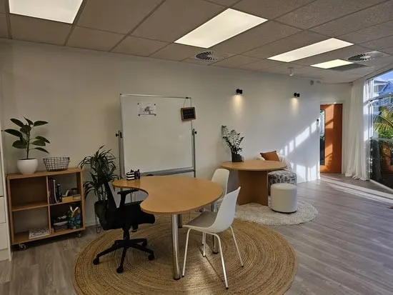 The tutoring corner at Prosford Studio, with a round table and a whiteboard